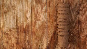 Empty peat pots for seedlings on a wooden background photo