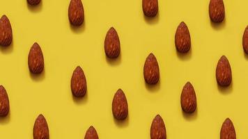 Rows of almonds on a yellow background photo