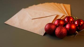 Christmas composition. Craft envelopes and red balls photo