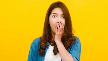 Asian female with positive expression over yellow background. photo