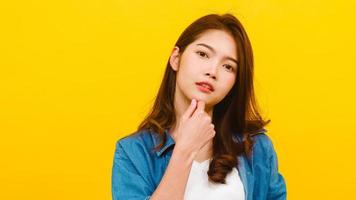 Asian female with positive expression over yellow background. photo