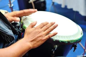 Playing the drum. Focus on the hand and other hand in motion photo