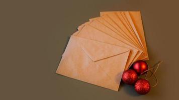 Christmas composition. Craft envelopes and red balls photo