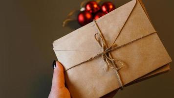 Christmas composition. Craft envelopes and red balls. Stack of letters photo