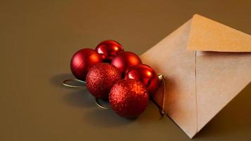 Christmas composition. Craft envelope and red balls photo