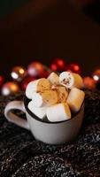 Christmas hot chocolate with marshmallow with lights bokeh photo