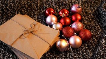 Stack of letters from craft paper with christmas red and pink balls photo