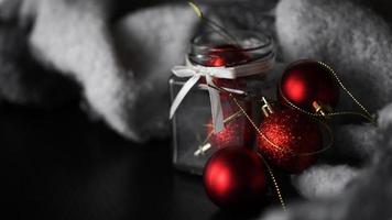 Small red Christmas balls in a glass jar photo