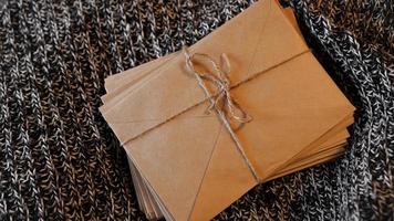 Bundle of letters tied with string on a knitted background photo