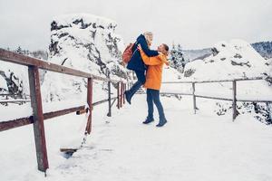 Guy and girl walk and have fun in the forest in winter