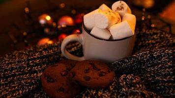 Mug with marshmallows and chocolate chip cookies photo