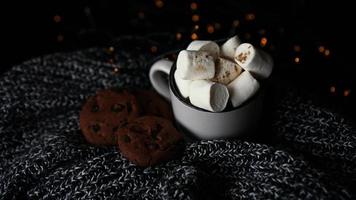 Mug with marshmallows and chocolate chip cookies photo