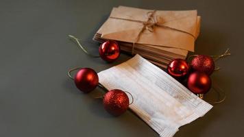 Christmas envelopes with a medical mask and red photo