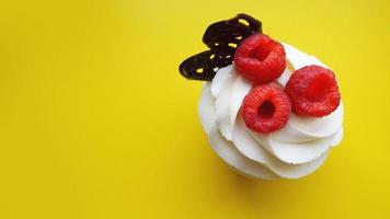 Homemade muffins with sweet cream and fresh red raspberries photo