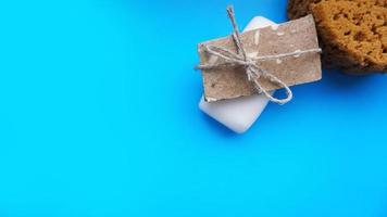 Handmade soap wrapped with twine on a blue clean background photo