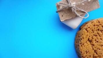 Handmade soap wrapped with twine on a blue clean background photo