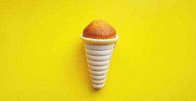 Icecream waffle cone isolated on yellow background photo