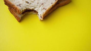 Bitten Toast on yellow background. View from above photo