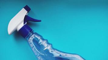 Spray with detergent on blue background photo