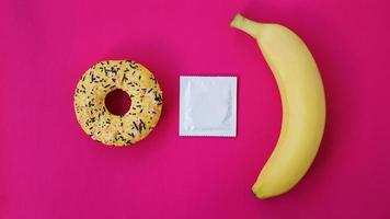 Banana, donut and condom. Sex idea. photo