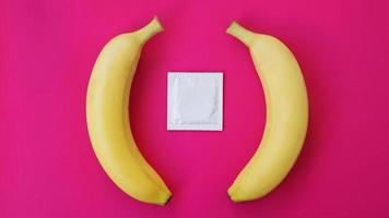 Condoms and two bananas together, concept of contraceptives photo