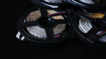 Coils of rgb led strip on a black table. Led strip photo