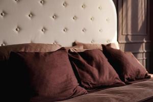 Hotel room bed with many pillows. photo