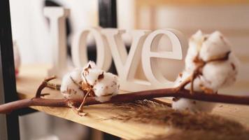 Love wooden letters, vintage styled and cotton flower photo