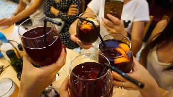 Cheerful company in the bar holds glasses photo