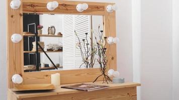 Table with makeup products and mirror photo