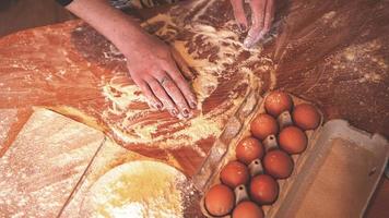 Close up scene of female hands making dough photo