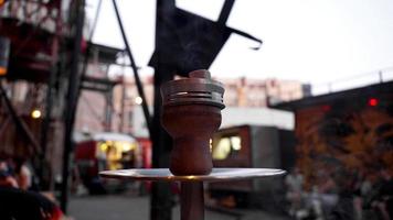 Close-up of a hookah bowl with charcoal. Hookah bar outside. photo