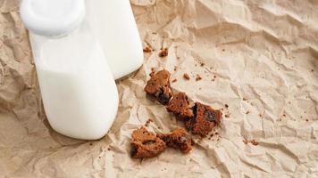 Fresh milk in a bottle and crumbs from chocolate