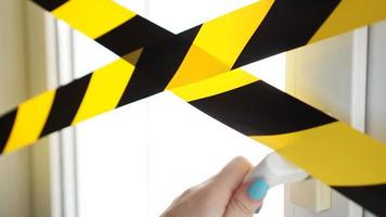 Coronavirus yellow tape Stay home. A hand reaches for the door handle photo