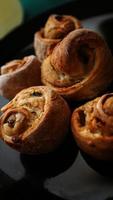 Chicken rolls from puff pastry on a black plate photo