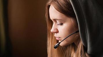 Portrait of a young girl in a hoodie and with a headset