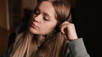 Portrait of a young girl in a hoodie and with a headset. photo