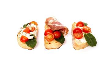 Three bruschetta on a ciabatta on a white plate. Italian appetizer photo