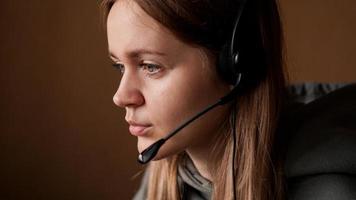 Portrait of a young girl in a hoodie and with a headset photo