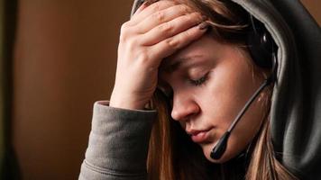 Portrait of young girl in a hoodie and with a headset photo