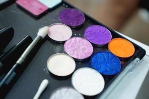 Palette of shadows for makeup on a blurred background, closeup photo