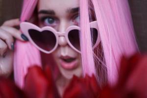 Surprised woman with tulip flowers - Pink hair photo