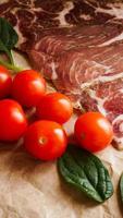 Meat slices and cherry tomatoes. Ingredients photo