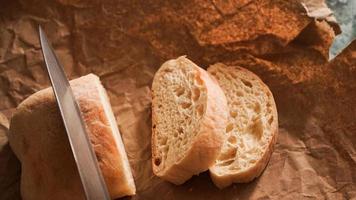 The chef slices the ciabatta with a knife. Ciabatta photo