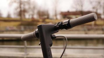 Close-up of the steering wheel of an electric scooter outside photo