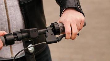 Electric scooter handlebar and man hand on the lever photo