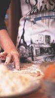 Close up scene of female hands making dough photo