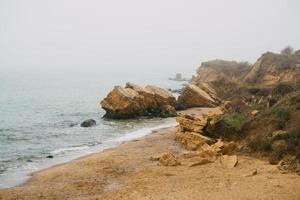 Yellow and red sandstone cliffs are located on the seafront photo