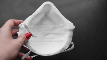 Female hand holds a respirator. Protection photo