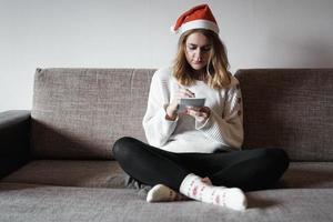 Portrait of pretty girl at Christmas writes plans for the new year photo